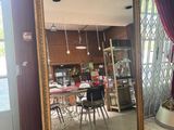a large mirror in the middle of a room with red curtains