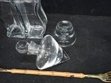 a glass vase and a wooden spoon on a black surface