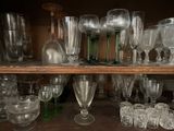 many glasses on a shelf in a room