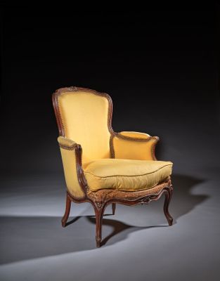 an image of a yellow chair with a yellow cushion in a dark room