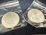 two coins that are in the bags on the table
