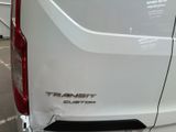 the rear end of a white van parked in a parking lot