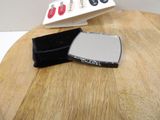 a small mirror and a wallet on a wooden table