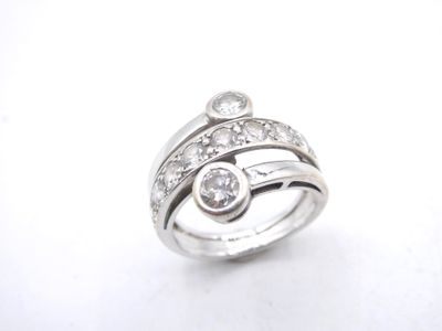 a close up of a diamond ring on a white surface