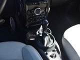a car dashboard with a gear stick in the center of it