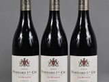 three bottles of wine sitting on top of a table next to each other