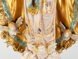 an image of a statue of the virgin of guadalupe in gold and blue