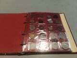 a red book with a bunch of coins inside of it