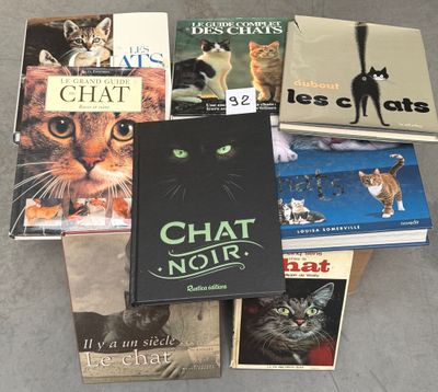 several books are stacked on top of each other on the floor