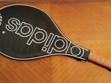 an image of a tennis racket sitting on top of a wooden table