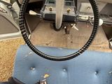 a steering wheel on the dashboard of an old car