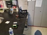 a desk with a phone and a bottle of water on it