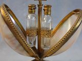 a gold and white vase with two salt and pepper shakers in it