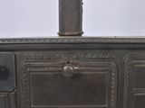 an old fashioned stove with a pot on top of it