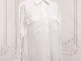 an image of a white shirt on a mannequin stand