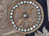 a close up of a piece of art with beads on it