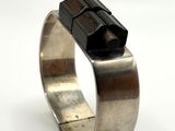 sterling silver ring with a black stone in the middle of it