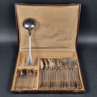a box of silverware with a spoon and spoon rest in it