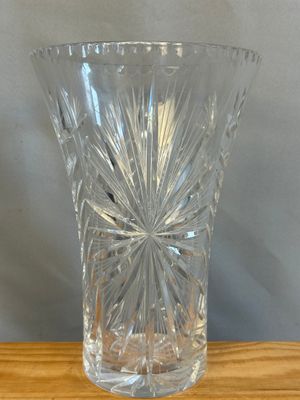 a clear glass vase sitting on a wooden table