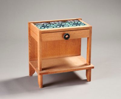 a small wooden table with a drawer on it
