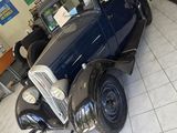 a vintage car that is on display in a showroom