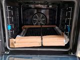 a large open oven with some pizzas in it