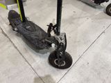 a scooter that is sitting on the floor in the garage