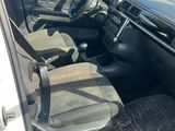 the interior of a car with the door open and the driver ' s seat down
