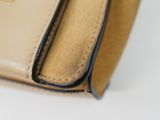 leather wallet on a white surface with a yellow tag