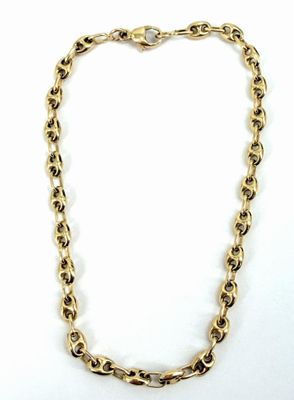 un collier à chaîne en or sur fond blanc