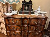 a dresser with a clock on top of it in a room