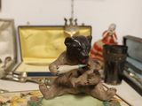 a figurine of a cat sitting on a table