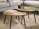 two tables that are sitting on the floor in the living room