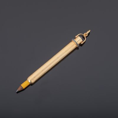 a close up of a pencil with a wooden handle on a black background
