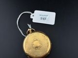 a close up of a gold coin with a tag attached to it