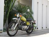 a green motorcycle parked on the side of the road