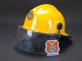 yellow hard hat with clear vise and badge on it