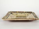 a small tray with a map on it on a white surface