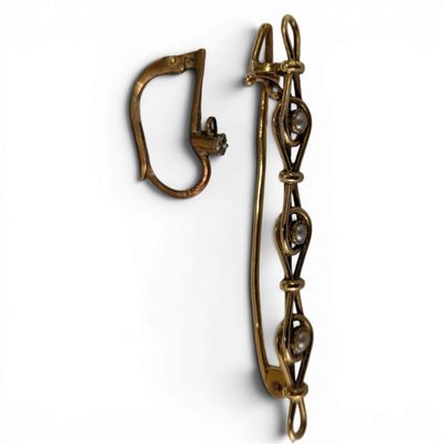 an image of a pair of brass ear clips on a white background