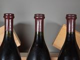 three bottles of wine sitting on top of a wooden crate