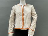 an image of a mannequin mannequin wearing a gold jacket and black skirt
