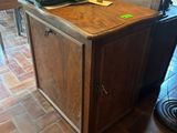 a kitchen island with a wooden top and a tile floor