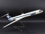 the model airplane is white and blue on a black background