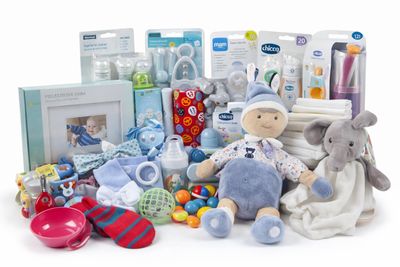 a pile of baby items that include a stuffed elephant, pacifier, bottle, rattler, rattler, rattler, rattler, rattler