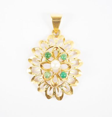 an image of a gold pendant with green and white stones