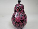 a black and pink vase sitting on a white surface