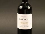 a close up of a bottle of wine on a black background
