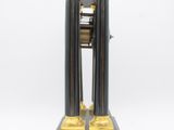 a black and gold clock sitting on a black stand