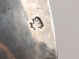 a close up of a silver spoon with numbers on it