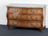 a marble top chest of drawers in the corner of a room
